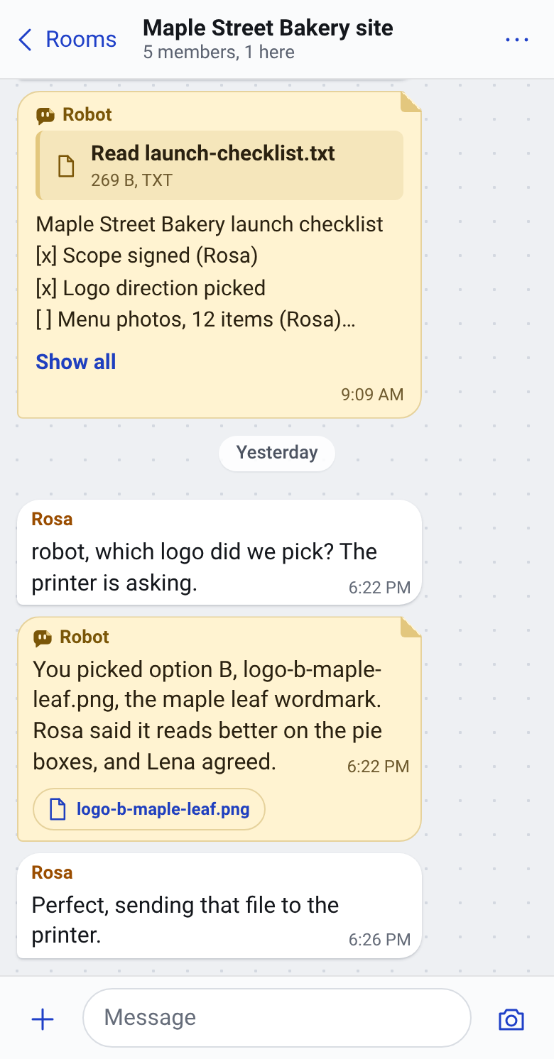 The sample project room on a phone. Rosa asks the robot which logo they picked, and the robot answers option B, logo-b-maple-leaf.png, with a link to the file.